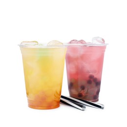 Tasty bubble tea in plastic cups and straws isolated on white