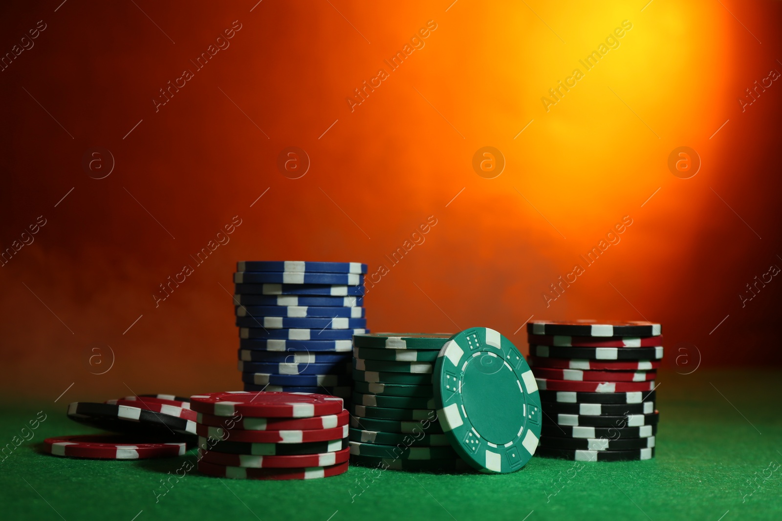 Photo of Poker game. Casino chips on green table