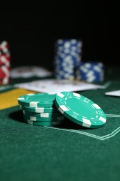 Photo of Poker game. Casino chips on green table, closeup