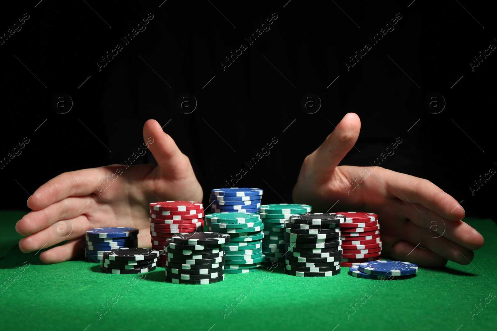 Photo of Woman with poker chips at green table, closeup