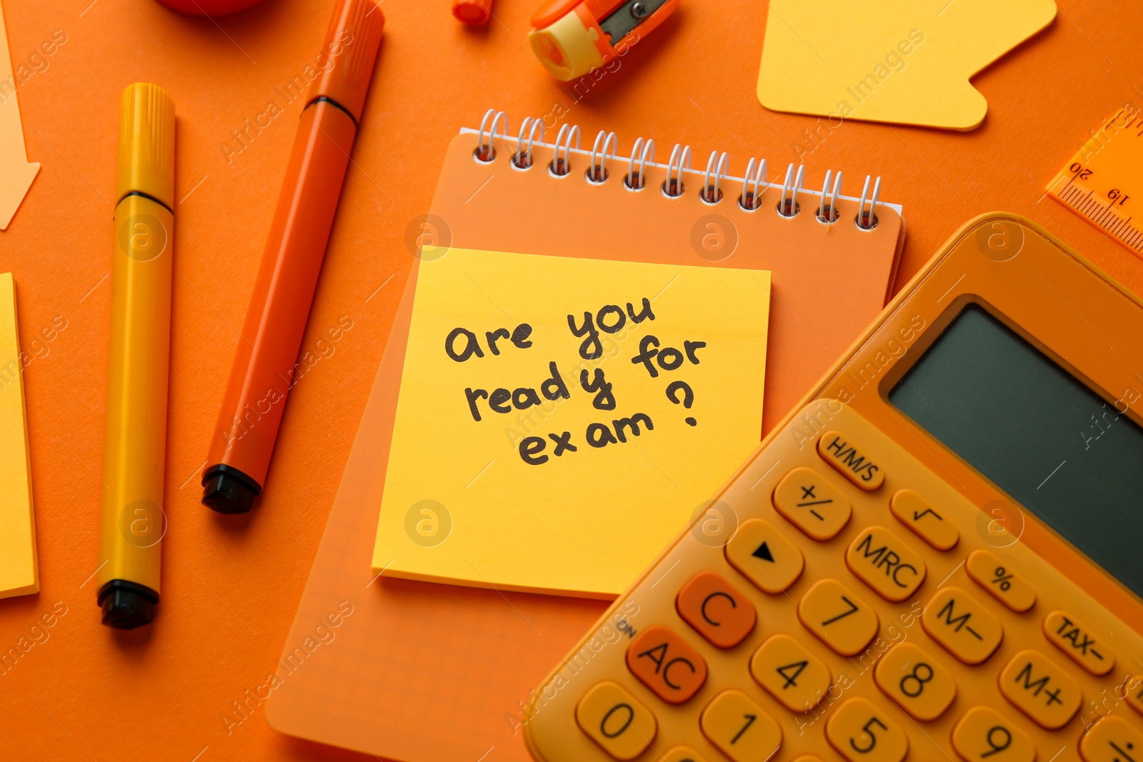 Photo of Paper note with question Are You Ready For Exam and stationery on orange background, flat lay