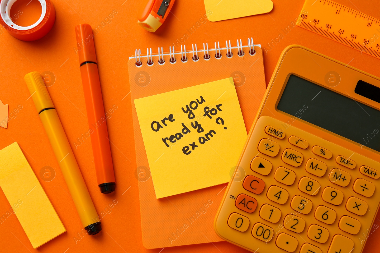 Photo of Paper note with question Are You Ready For Exam and stationery on orange background, flat lay