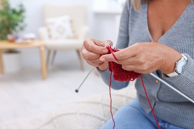 Photo of Woman knitting at home, closeup. Space for text