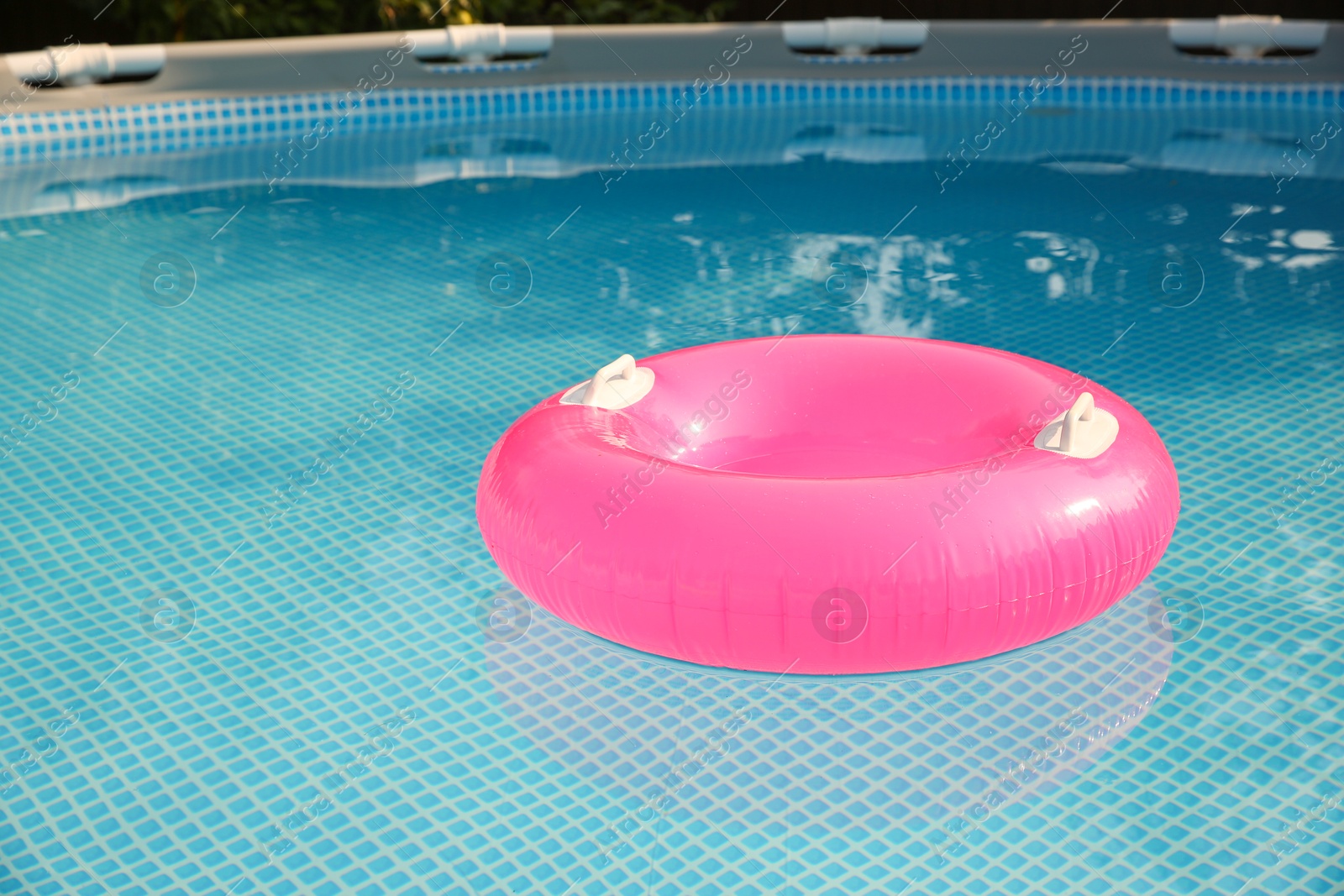 Photo of Inflatable ring on water in swimming pool outdoors