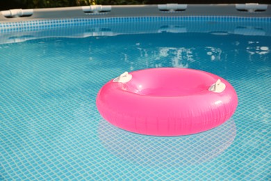 Photo of Inflatable ring on water in swimming pool outdoors