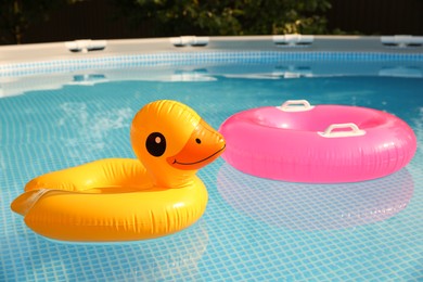 Photo of Inflatable rings on water in above ground swimming pool outdoors