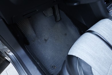 Photo of Grey rubber car floor mat in auto