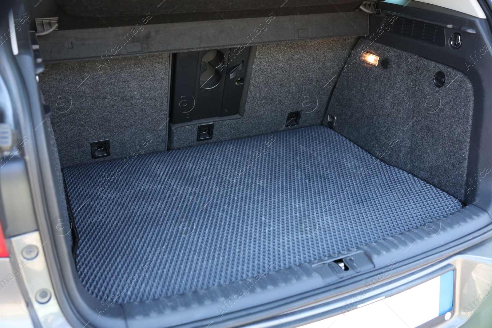 Photo of Grey rubber car boot liner mat in trunk of auto