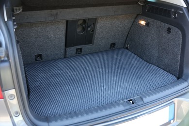 Photo of Grey rubber car boot liner mat in trunk of auto