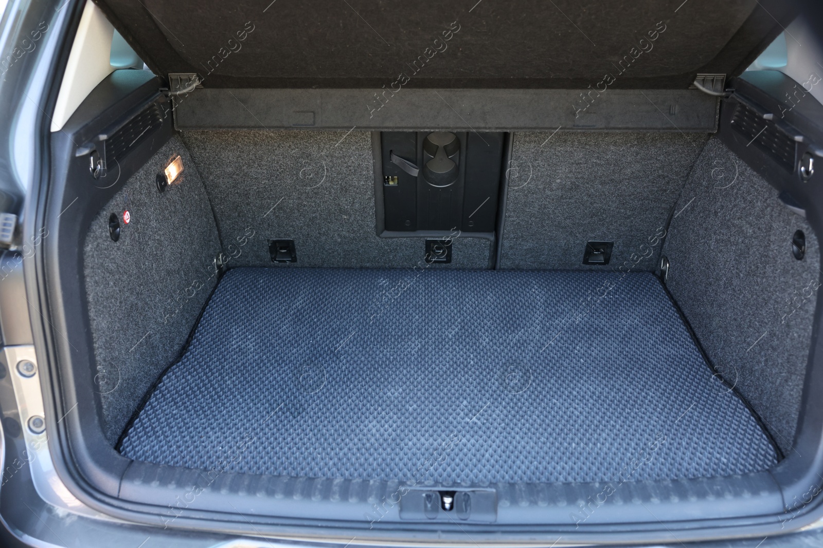 Photo of Grey rubber car boot liner mat in trunk of auto