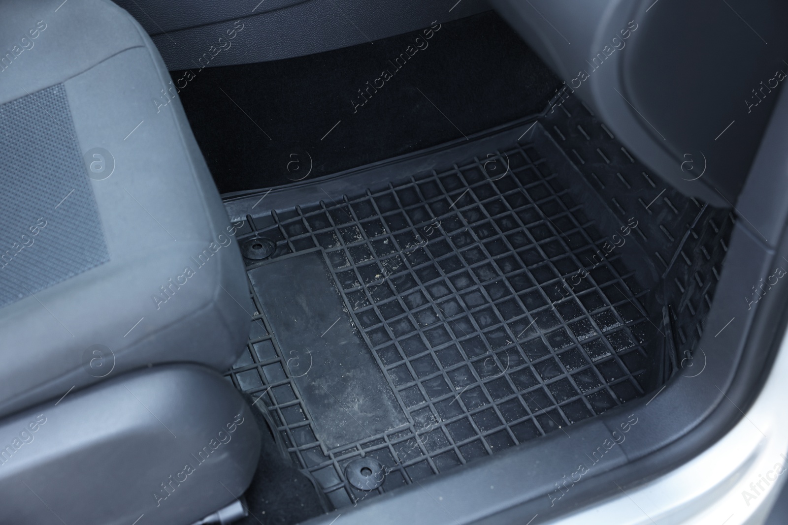 Photo of Black rubber car floor mat in auto