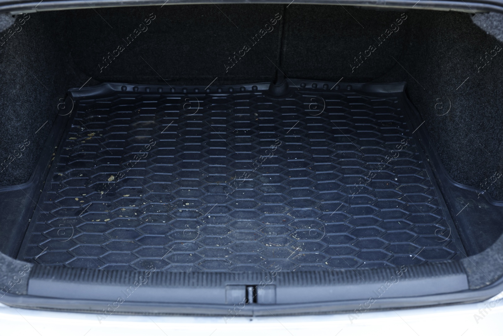 Photo of Black rubber car boot liner mat in trunk of auto