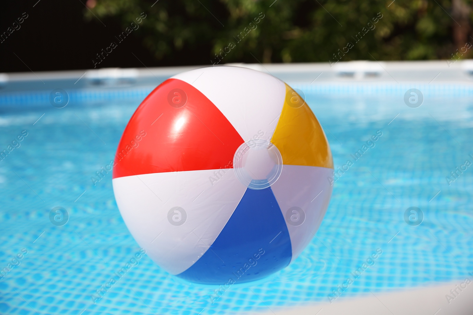 Photo of Inflatable ball in above ground swimming pool outdoors on sunny day