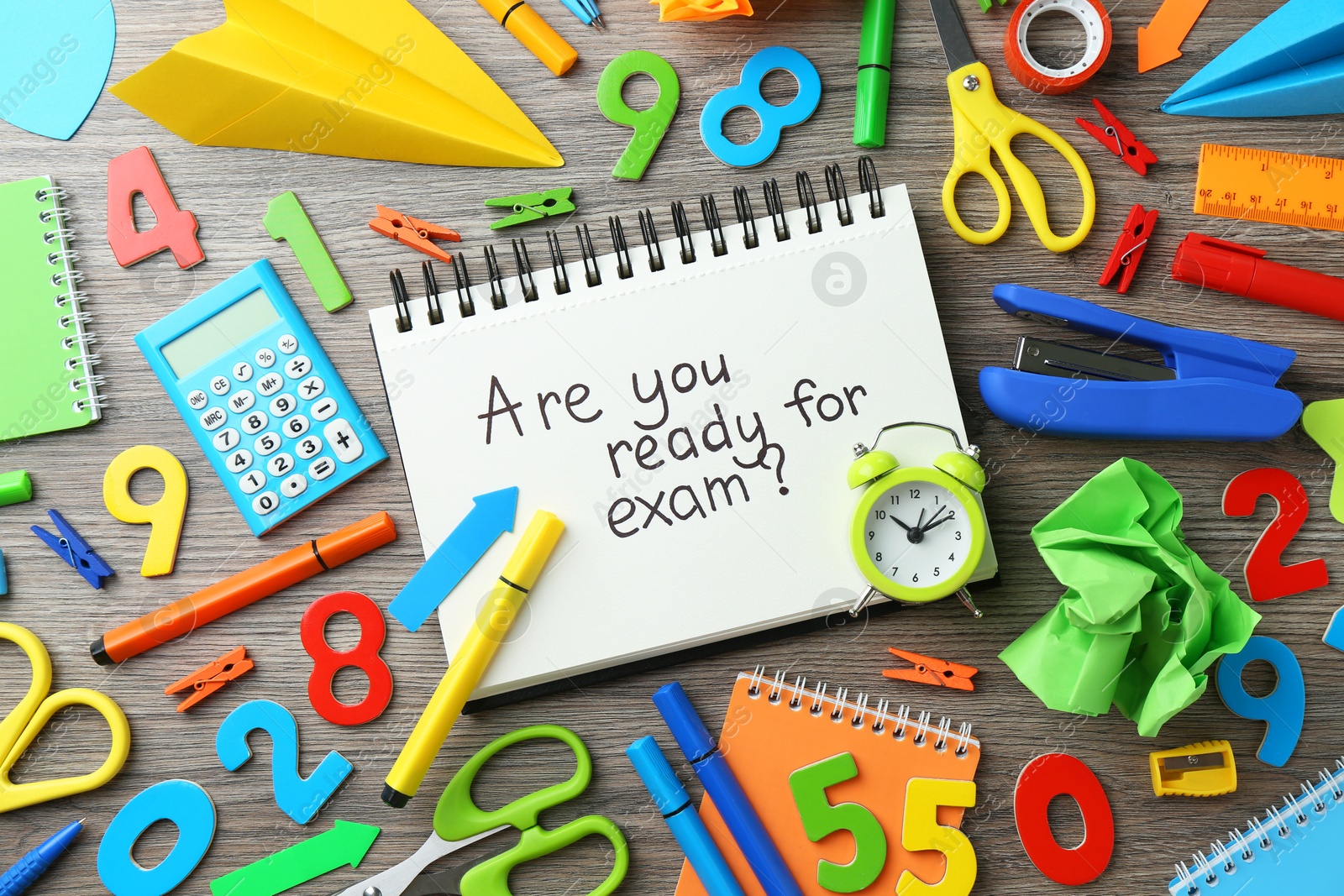 Photo of Notepad with question Are You Ready For Exam and stationery on wooden desk, flat lay