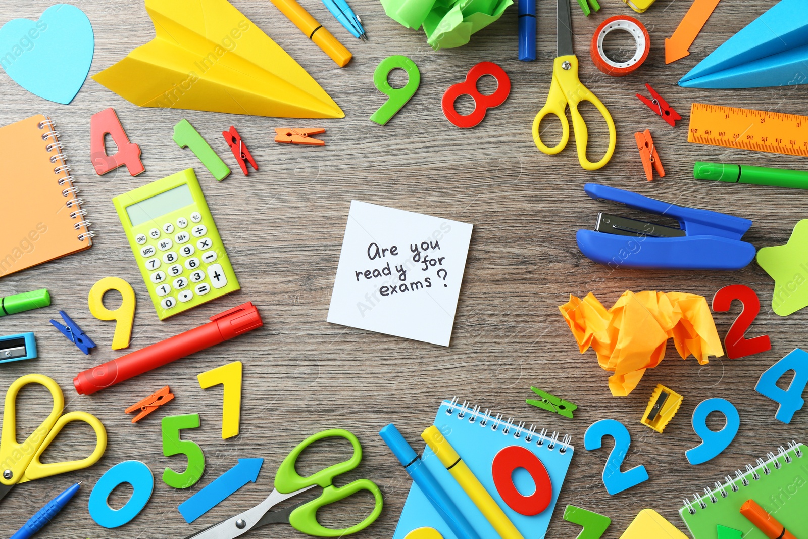 Photo of Note with question Are You Ready For Exams and stationery on wooden desk, flat lay