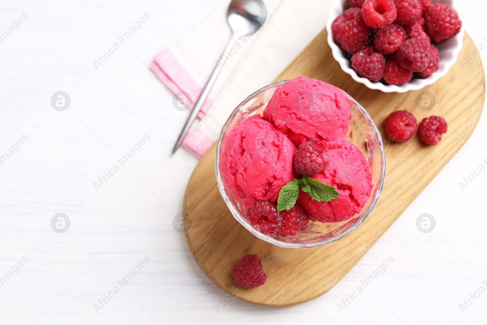 Photo of Delicious raspberry sorbet, mint and fresh berries on white wooden table, top view. Space for text