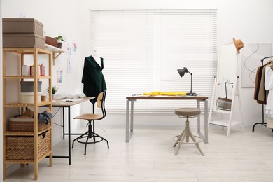 Photo of Fashion designer`s workplace with fabric samples and sewing supplies