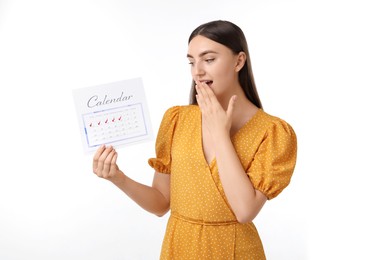 Photo of Woman holding calendar with marked menstrual cycle days on white background