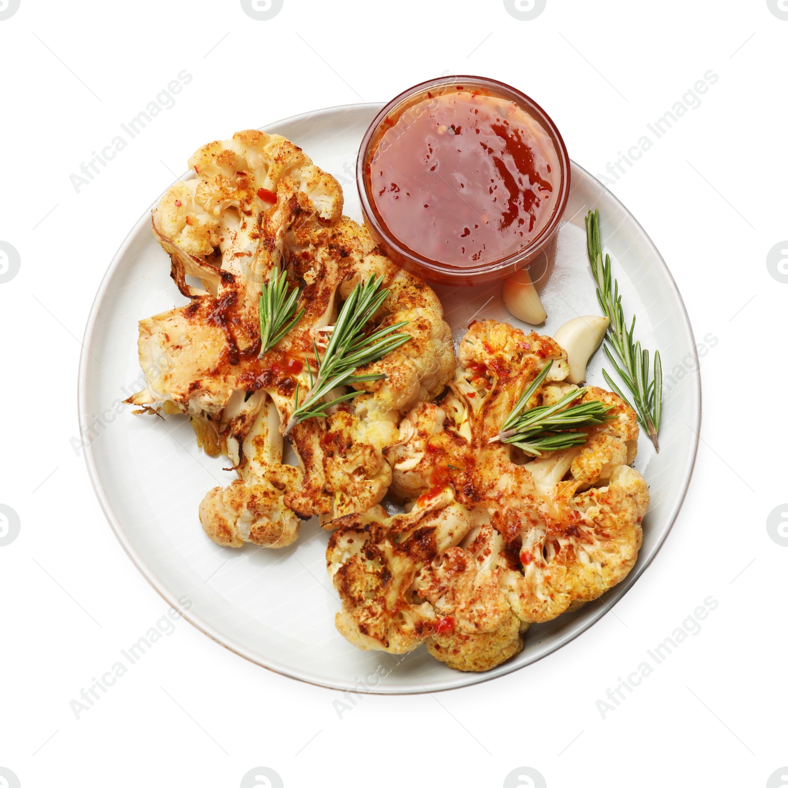 Photo of Delicious baked cauliflower steaks with sauce isolated on white, top view