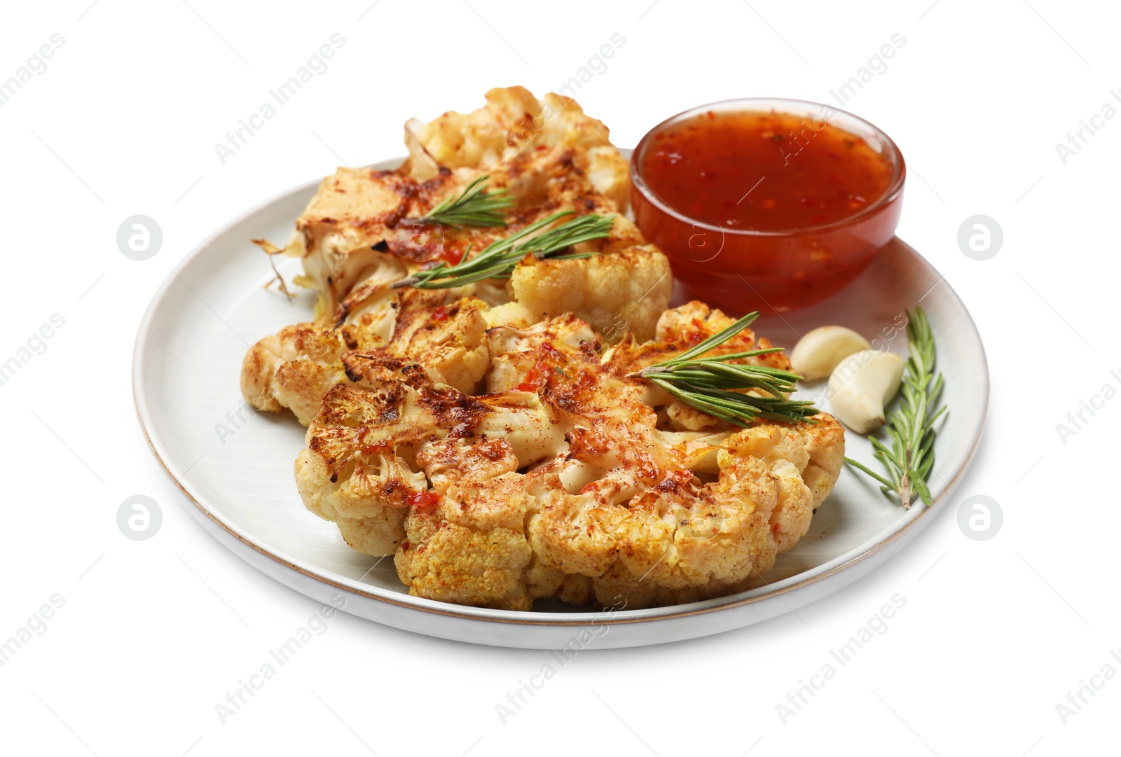 Photo of Delicious baked cauliflower steaks with sauce isolated on white