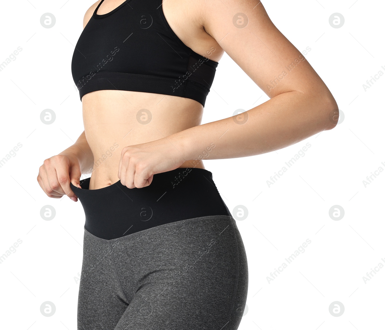 Photo of Woman wearing sports leggings and bra on white background, closeup