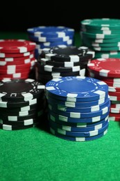 Photo of Poker game. Casino chips on green table, closeup