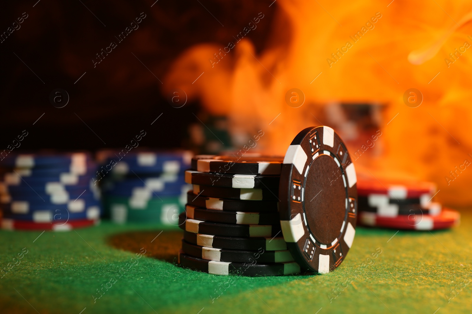 Photo of Poker game. Casino chips on green table, closeup