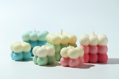 Photo of Many beautiful bubble candles on light background