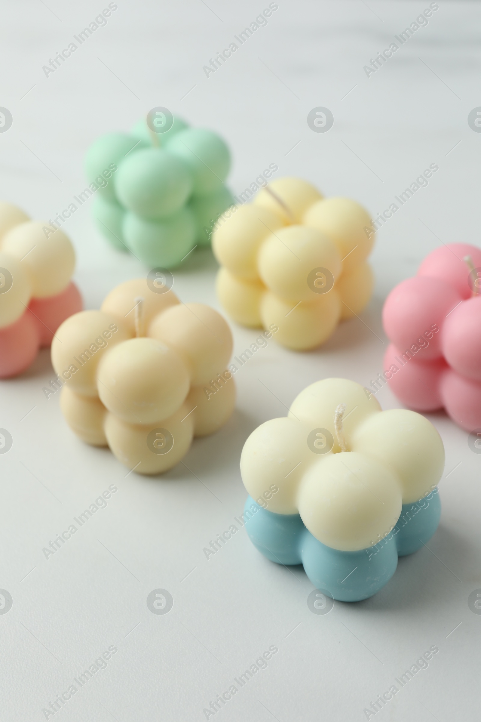 Photo of Different stylish bubble candles on white table, closeup