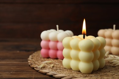 Photo of Different stylish bubble candles on wooden table, closeup. Space for text