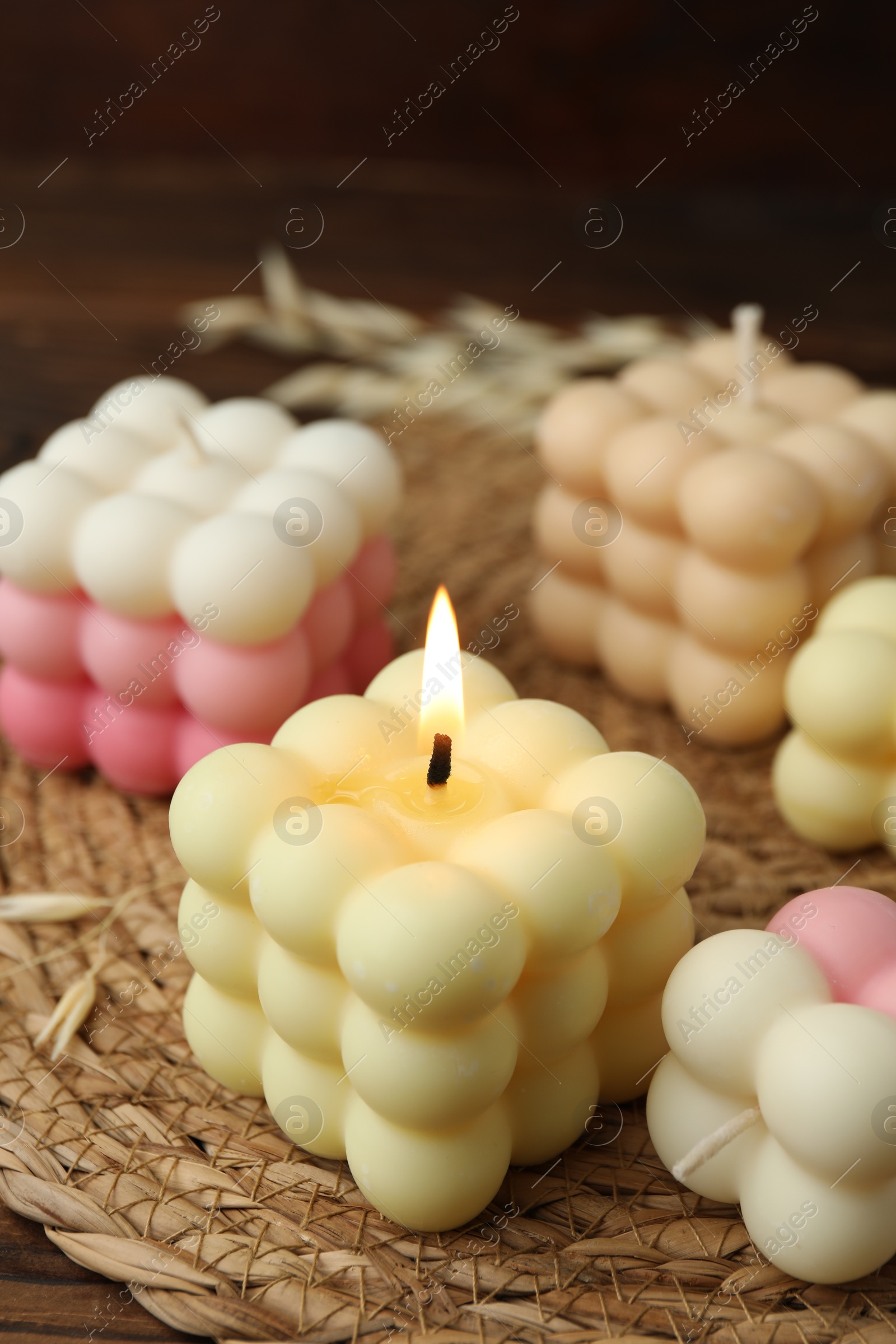 Photo of Different stylish bubble candles on wooden table, closeup