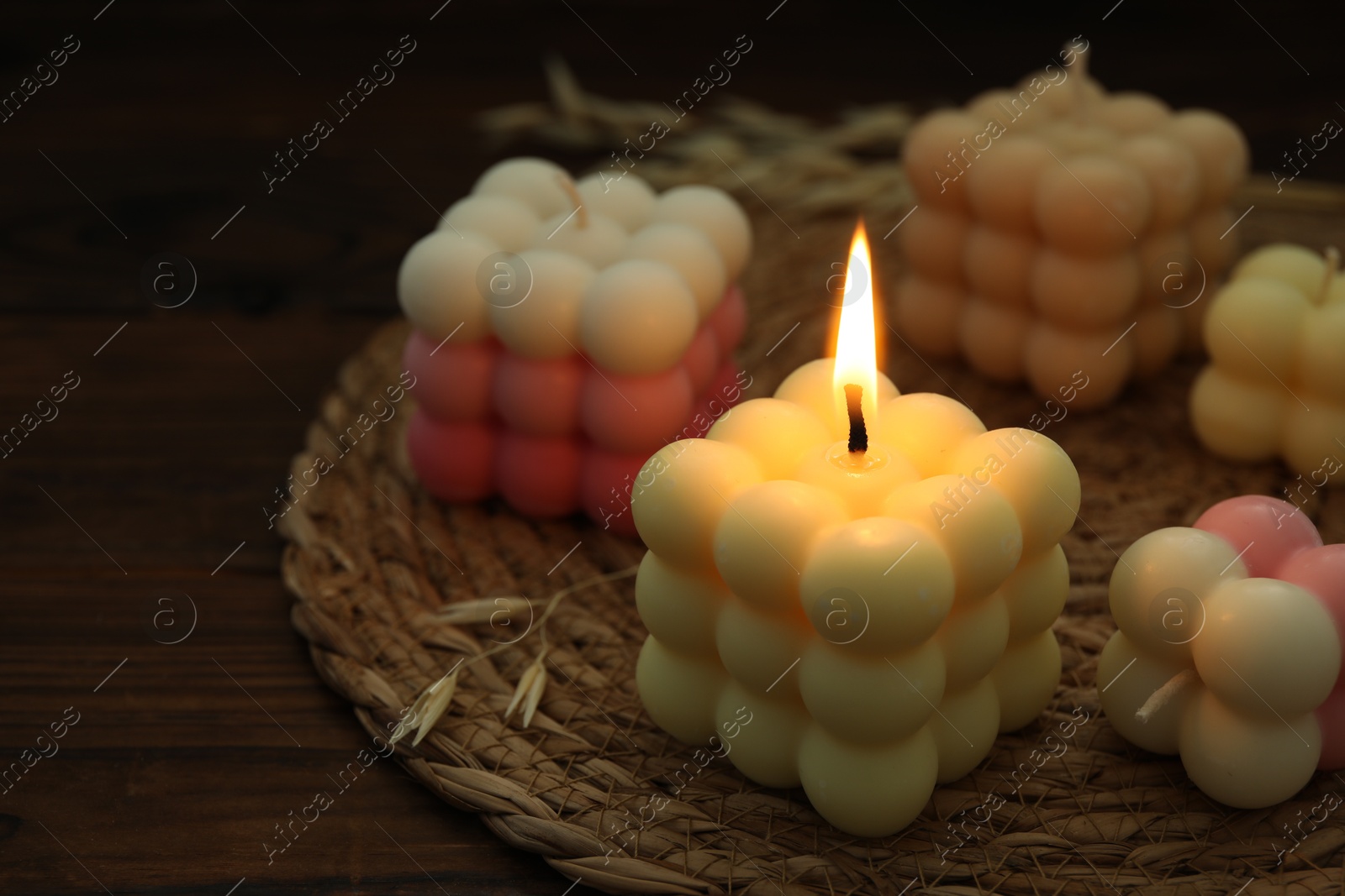 Photo of Different stylish bubble candles on wooden table, closeup. Space for text