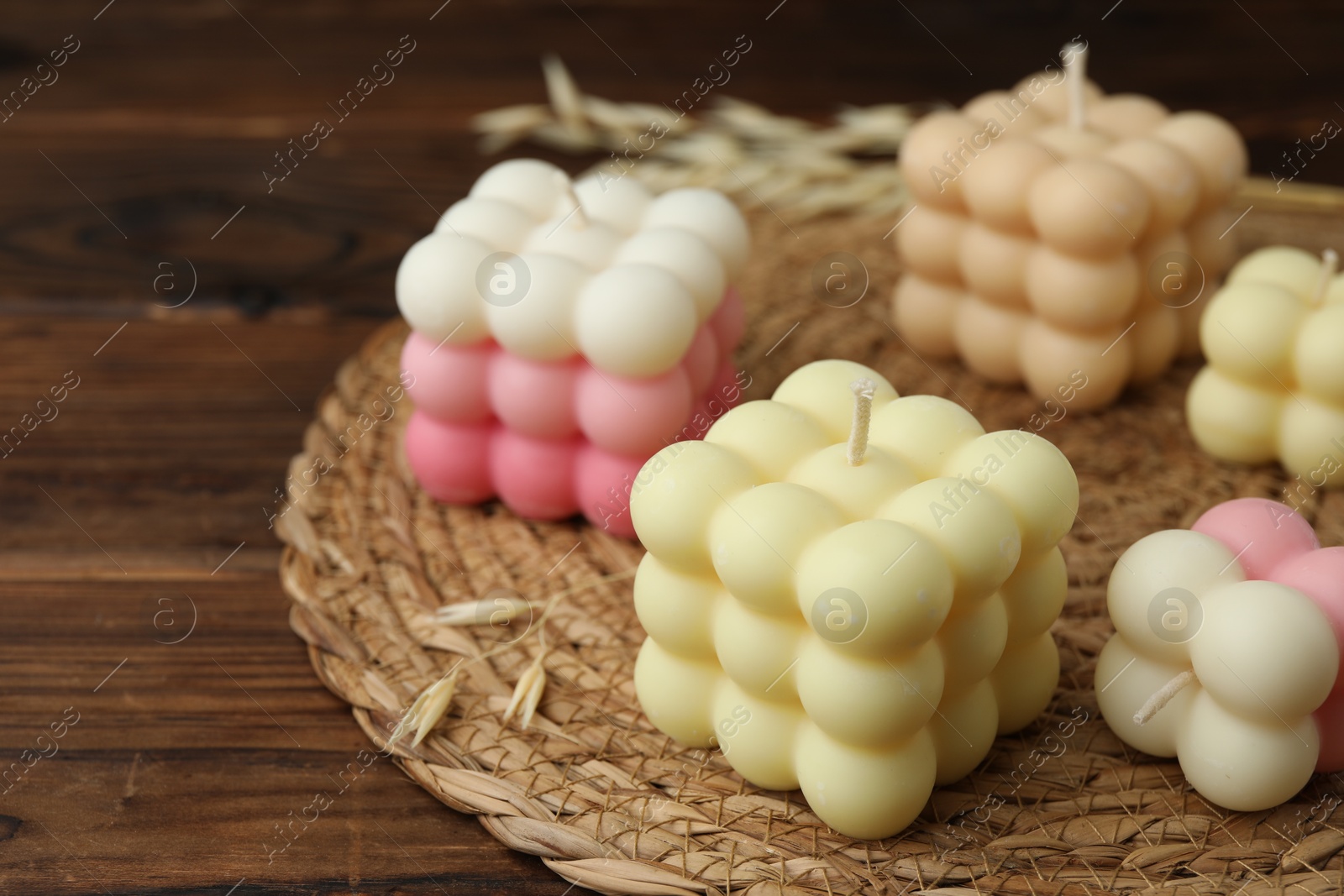 Photo of Different stylish bubble candles on wooden table, closeup. Space for text