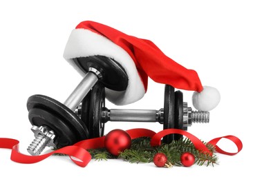 Photo of Dumbbells and Christmas decor isolated on white