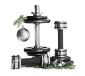 Photo of Dumbbells and Christmas decor isolated on white