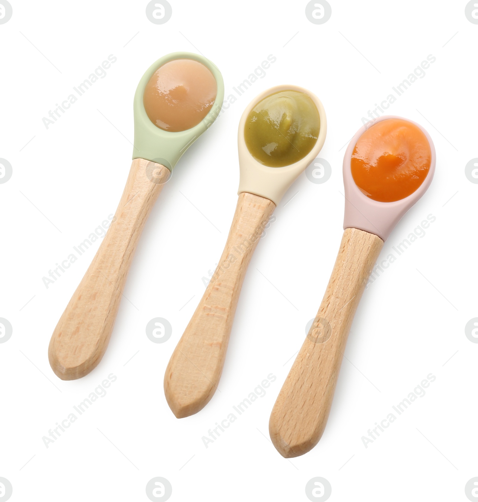 Photo of Spoons with different baby food isolated on white