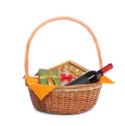 Photo of Wicker gift basket with wine isolated on white