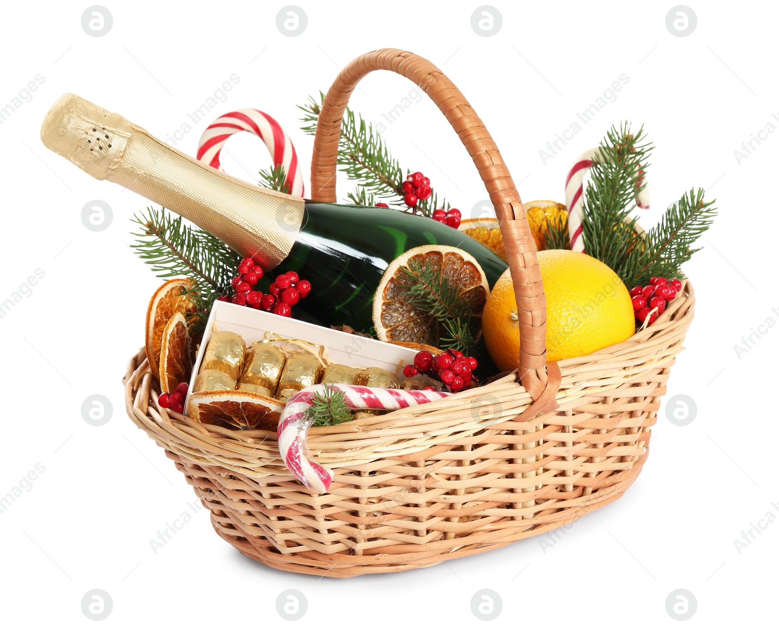 Photo of Wicker gift basket with sparkling wine and Christmas decor isolated on white