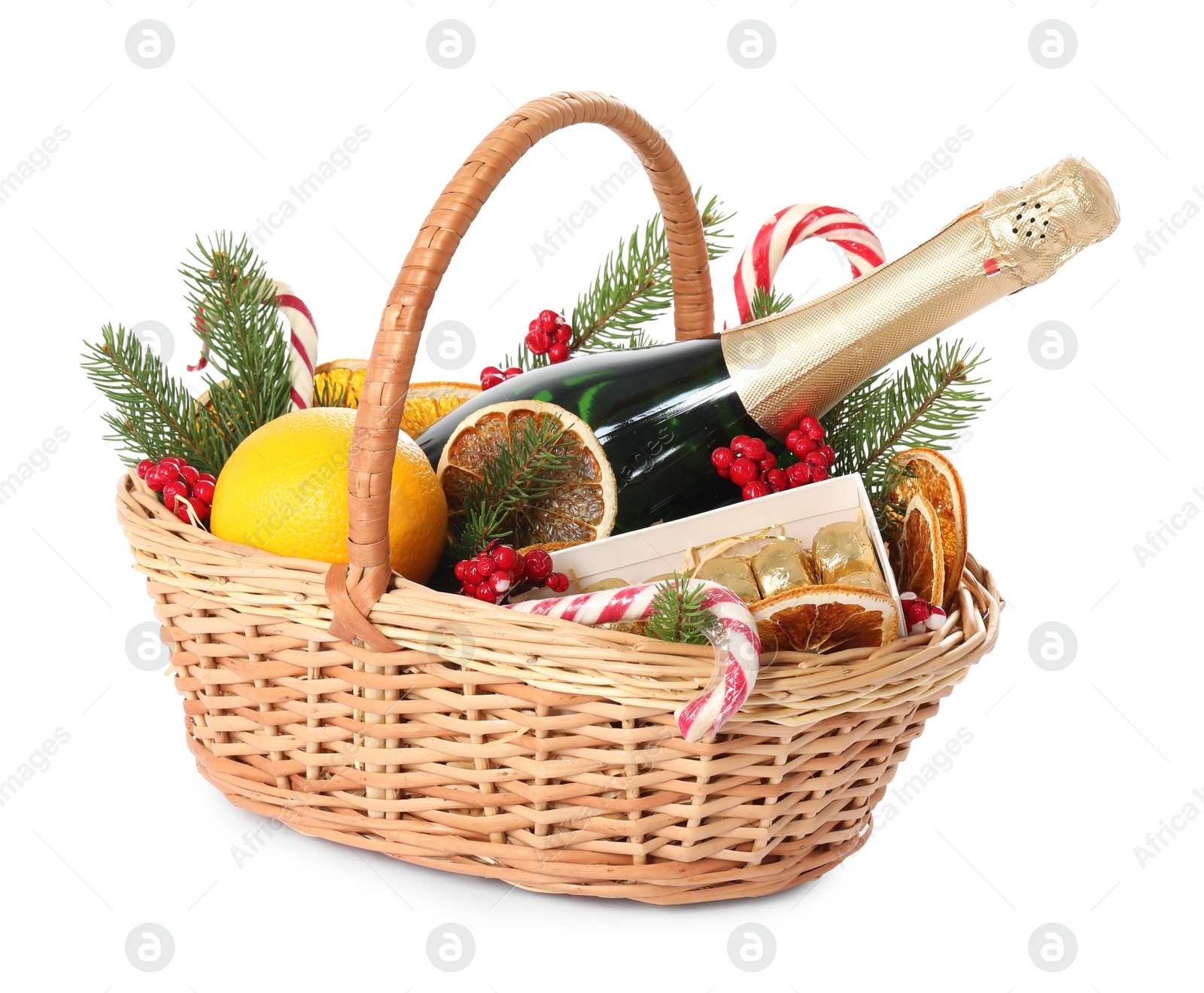 Photo of Wicker gift basket with sparkling wine and Christmas decor isolated on white