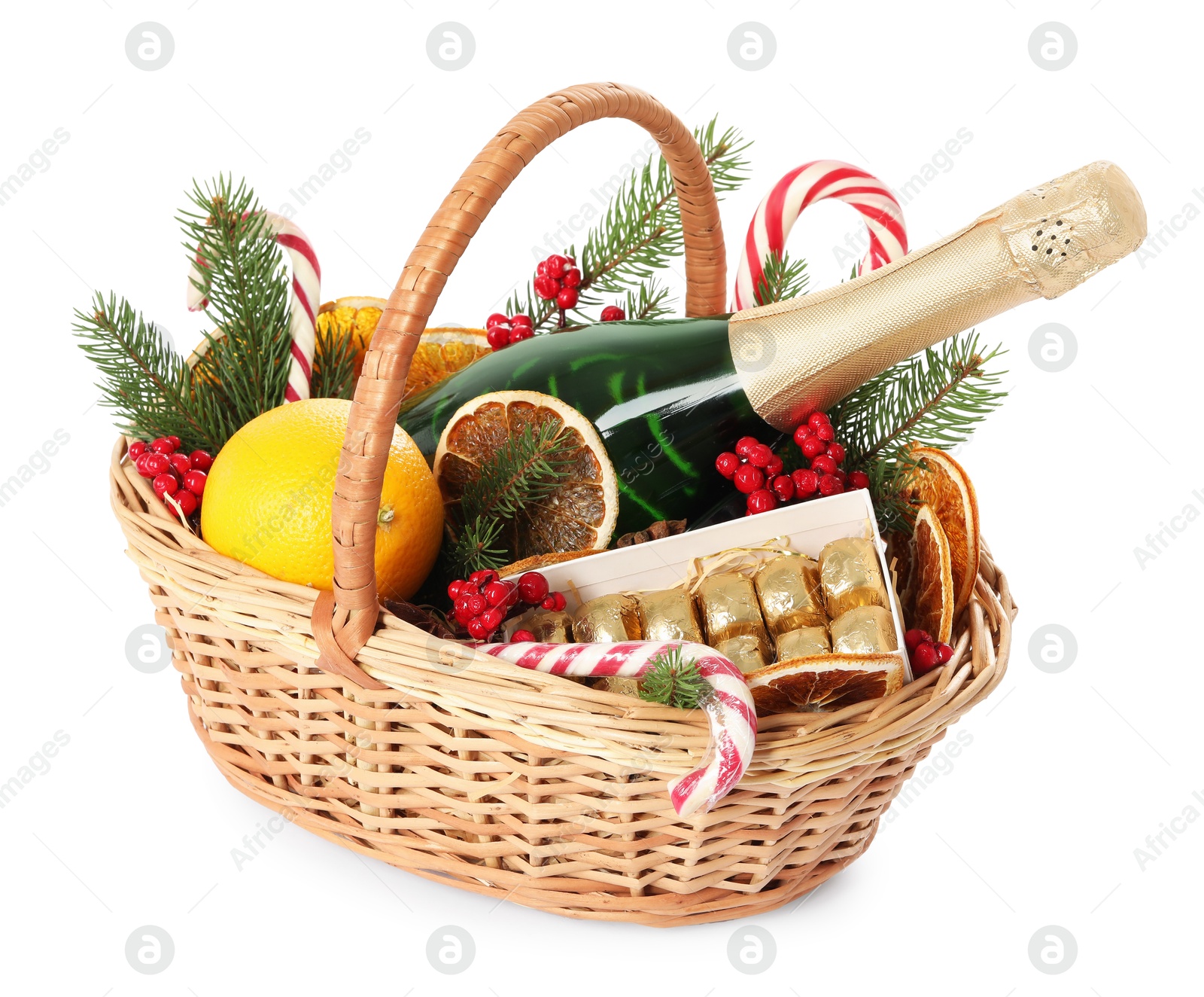 Photo of Wicker gift basket with sparkling wine and Christmas decor isolated on white