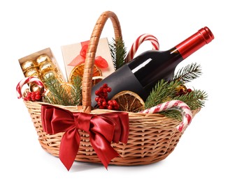 Wicker gift basket with wine and Christmas decor isolated on white