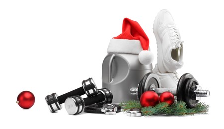 Photo of Dumbbells, container with supplement, sneakers and Christmas decor isolated on white