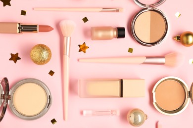 Photo of Different makeup brushes, decorative cosmetics and Christmas decor on pink background, flat lay