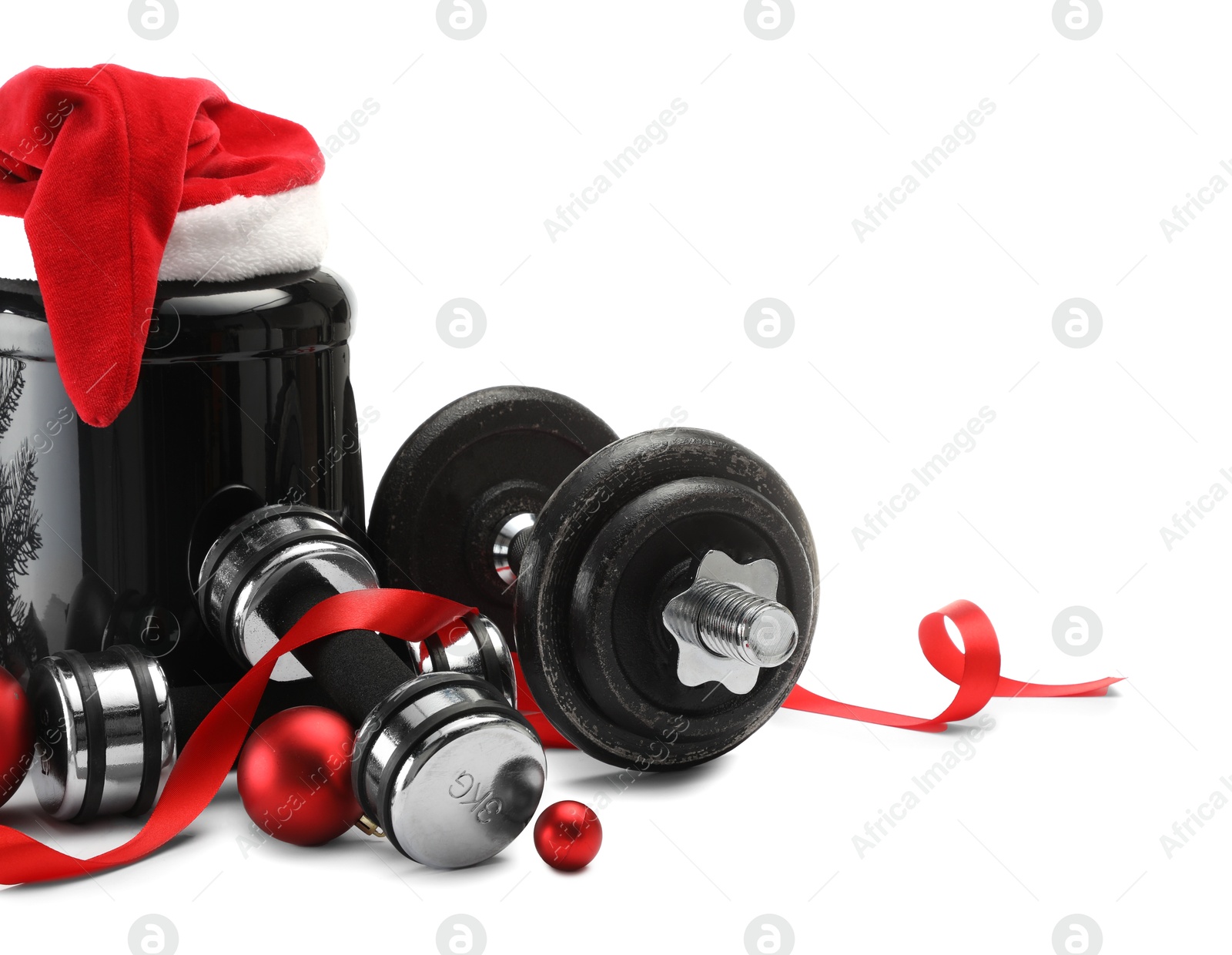 Photo of Dumbbells, container with supplement and Christmas decor isolated on white