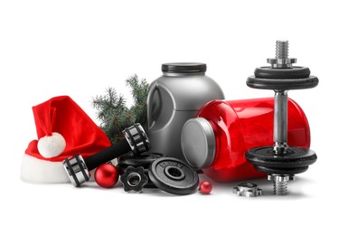 Photo of Dumbbells, containers with supplement and Christmas decor isolated on white