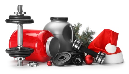 Photo of Dumbbells, containers with supplement and Christmas decor isolated on white