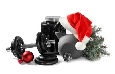 Photo of Dumbbells, kettlebell and Christmas decor isolated on white