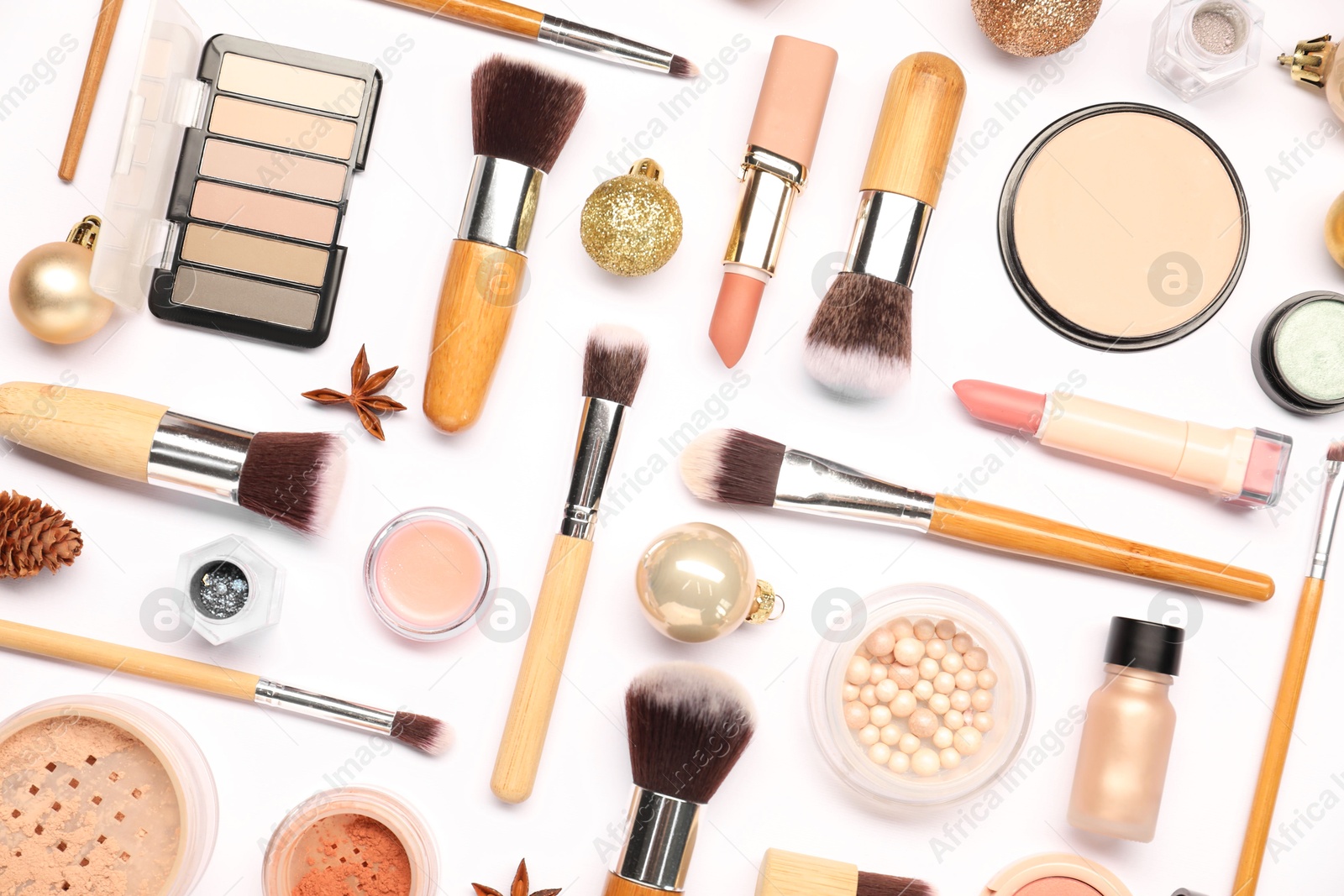 Photo of Different makeup brushes, decorative cosmetics and Christmas decor on white background, flat lay