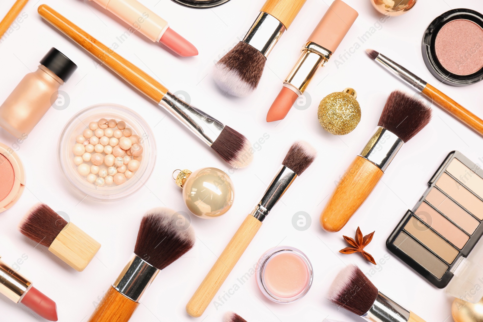 Photo of Different makeup brushes, decorative cosmetics and Christmas decor on white background, flat lay