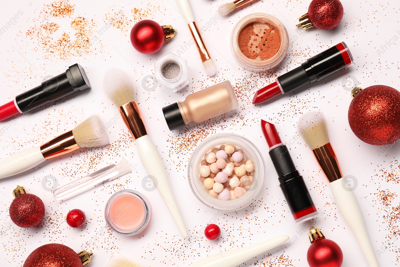 Photo of Different makeup brushes, decorative cosmetics and Christmas decor on white background, flat lay